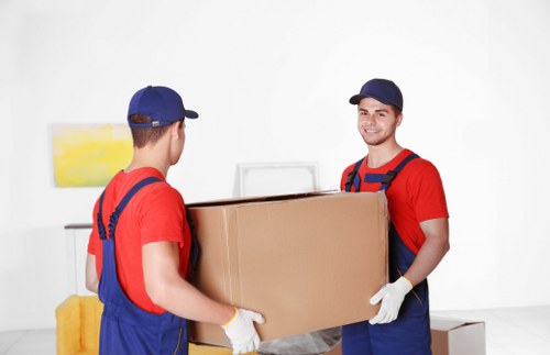 Removal team loading household items into a moving van