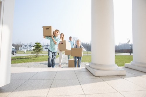 Professional movers handling office furniture for a Brompton business