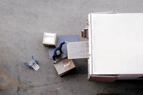 Man with a van loading items in Brompton residential area